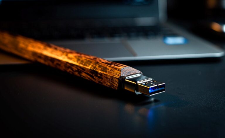Illustration von einem unscheinbaren Bleistift, dessen Mine sich als USB-Stecker entpuppt und in einen Laptop gesteckt wird.